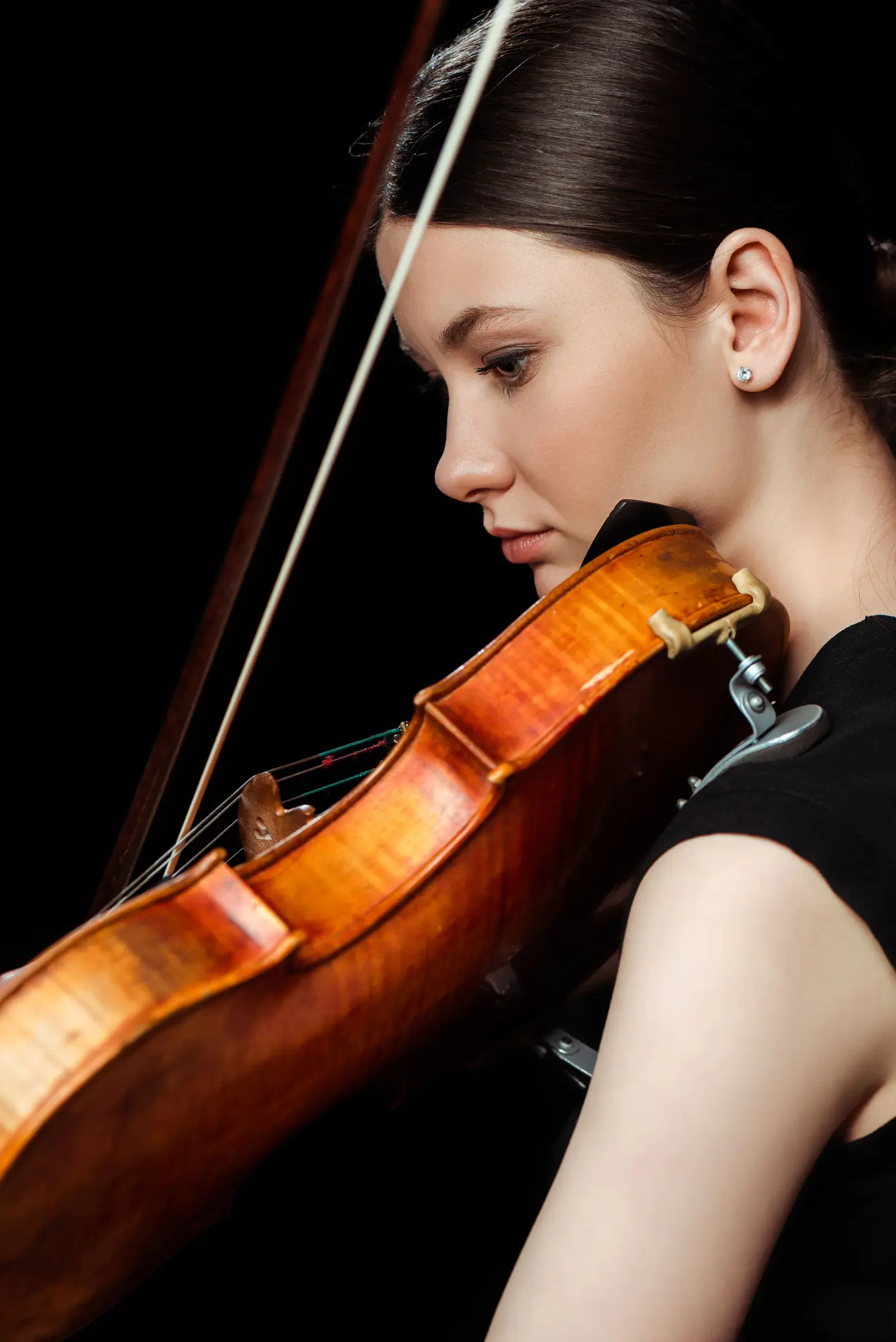 Violinist preparing to perform from a professionally engraved score.