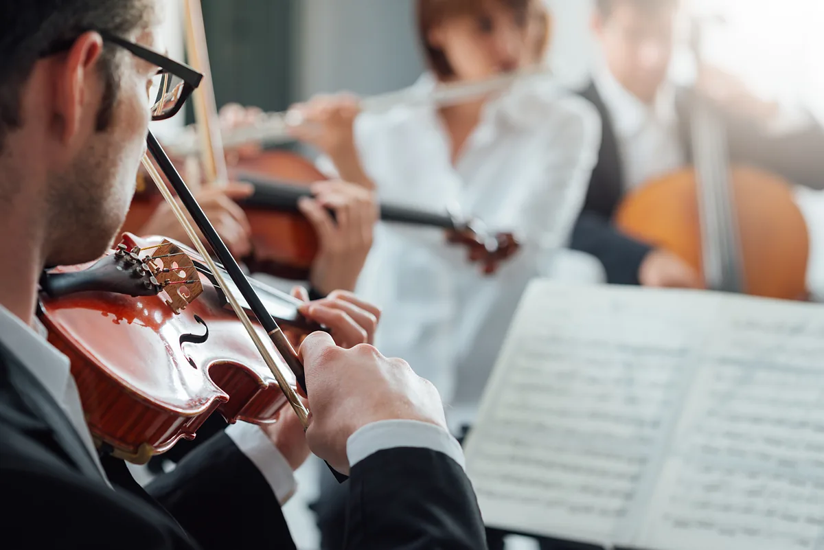 String players performing together in an orchestra.