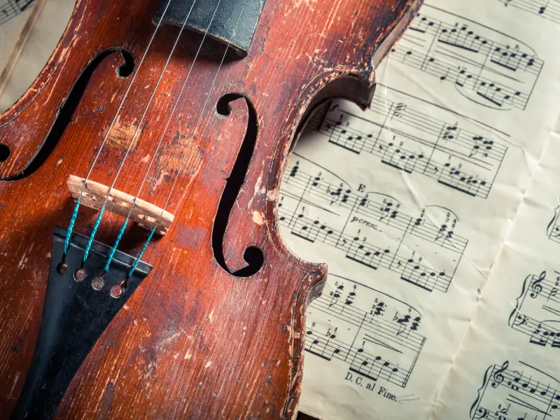 Violin resting on vintage printed sheet music