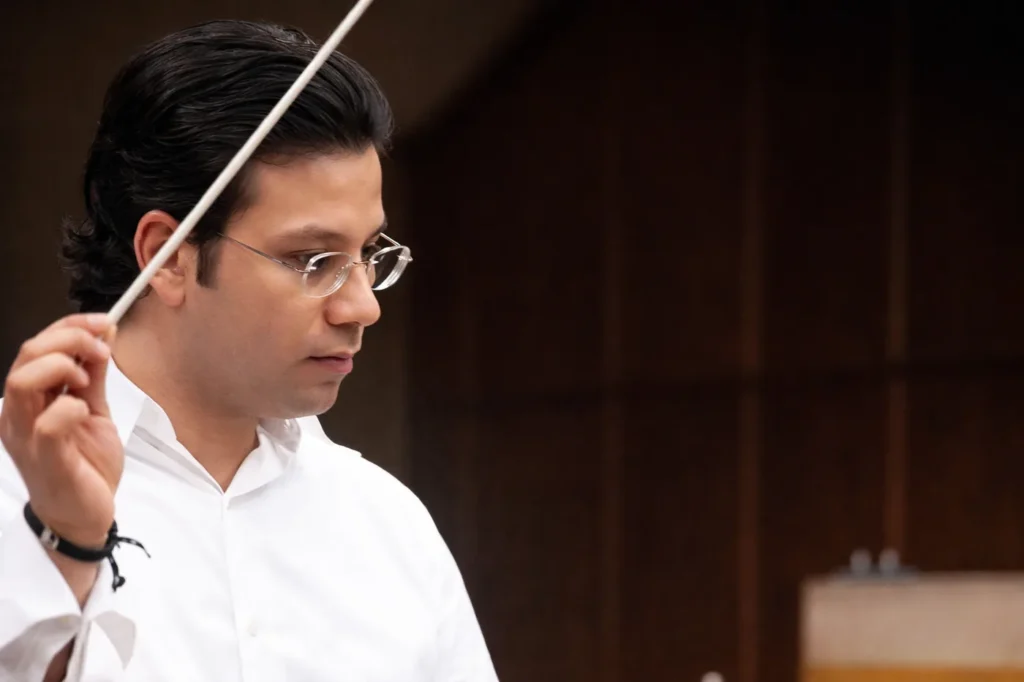 Samy Elgazzar conducting an ensemble in performance.