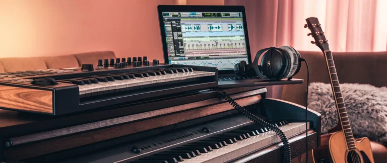 A home studio with a MIDI keyboard and a DAW session open on a laptop