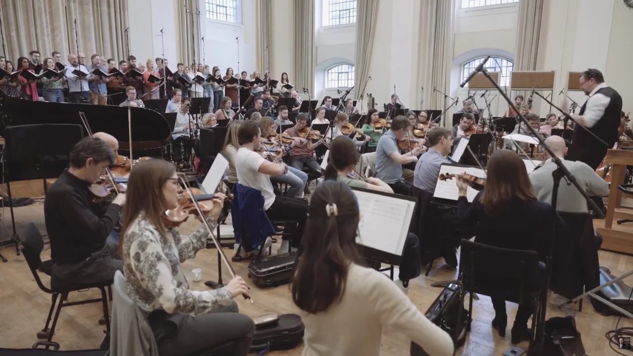 The Royal Philharmonic Orchestra and City of London Choir recording Anthem in the studio, with the conductor at right.